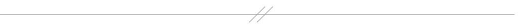 Thin horizontal gray line broken by two short, parallel diagonal lines.