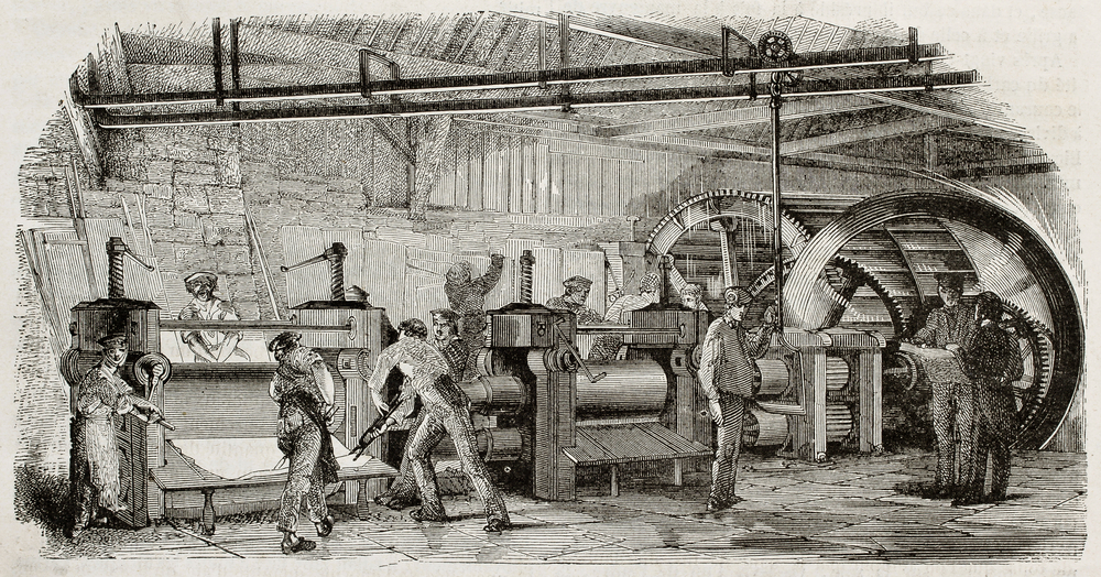 Industrial factory scene with workers operating large machinery and presses.